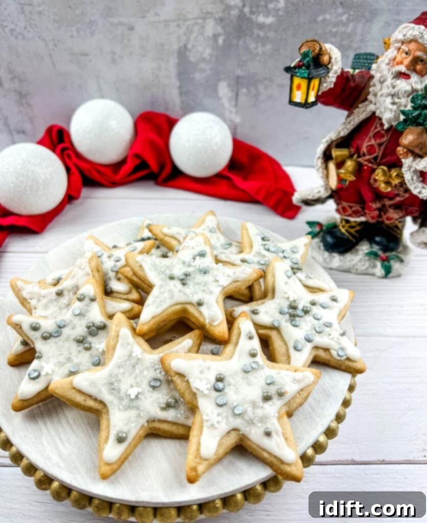 eggnog sugar cookies beautifully decorated and arranged on a simple white plate