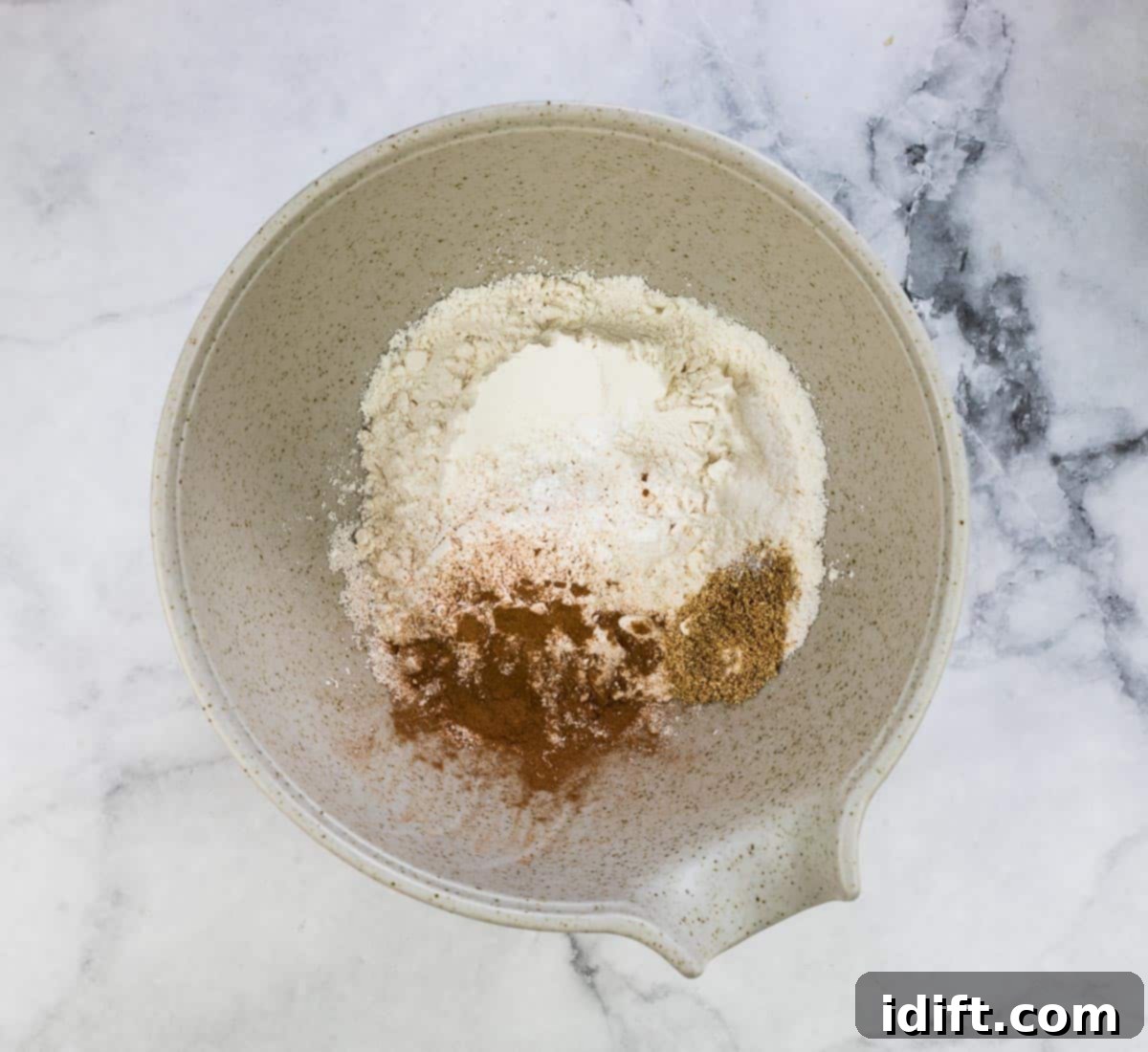 mixing the dry ingredients in a bowl with a whisk