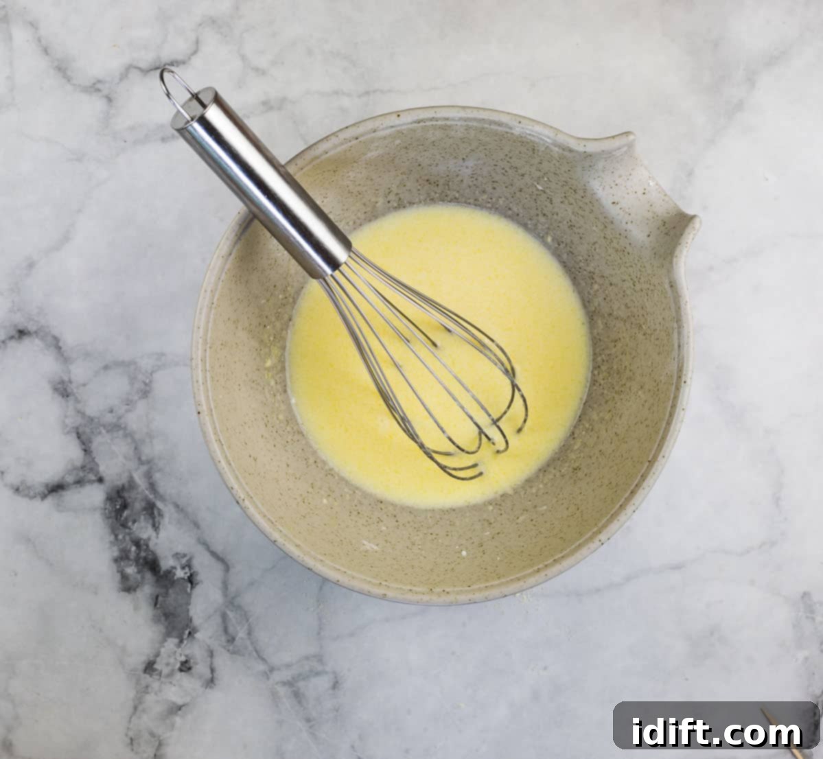 wet ingredients mixed to make honey butter cornbread madeleines