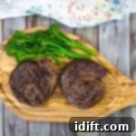 Smoked ribeye cap steaks on a cutting board, garnished and ready for serving.