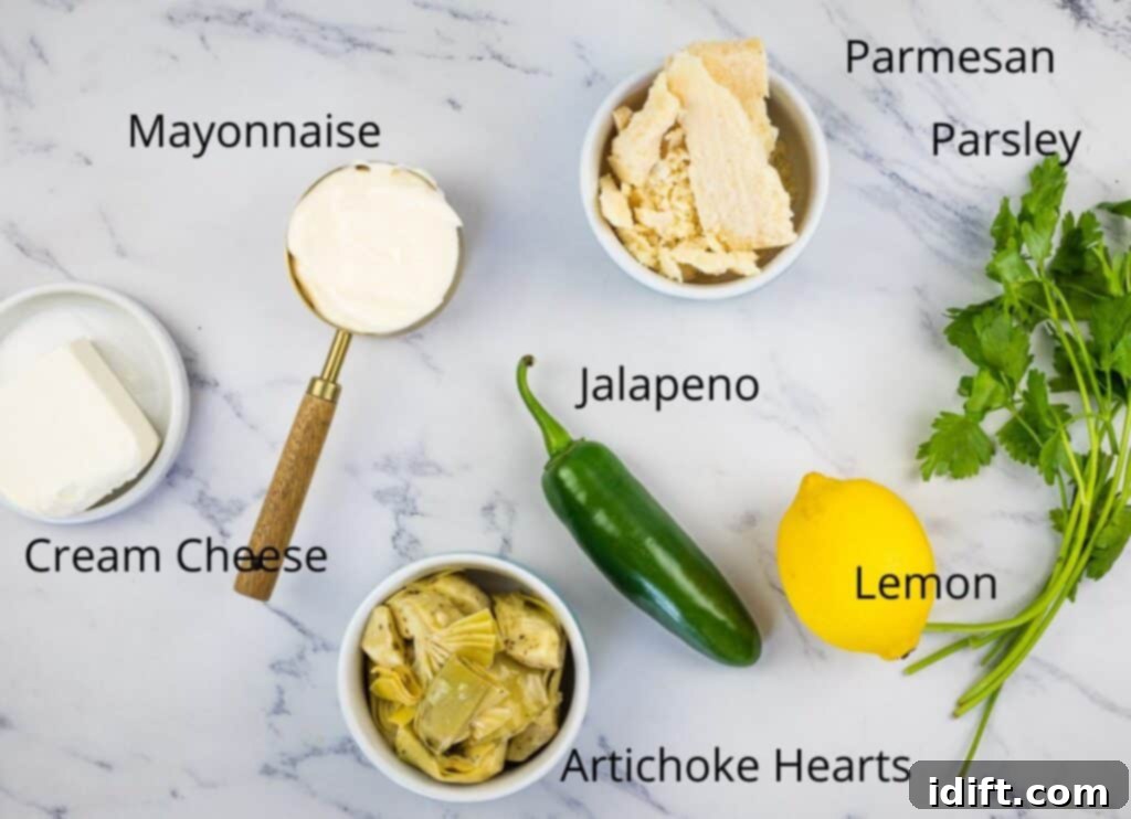 Creamy Jalapeno Artichoke Dream 4 A perfectly arranged display of fresh ingredients for Artichoke Jalapeno Dip, including marinated artichoke hearts, block Parmesan, cream cheese, mayonnaise, parsley, lemon, and whole jalapenos, ready for preparation.