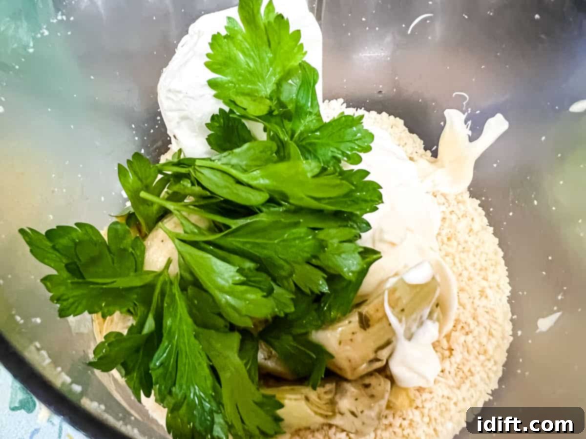 Creamy Jalapeno Artichoke Dream 6 All the main ingredients, excluding diced jalapenos, placed in a food processor bowl for blending.