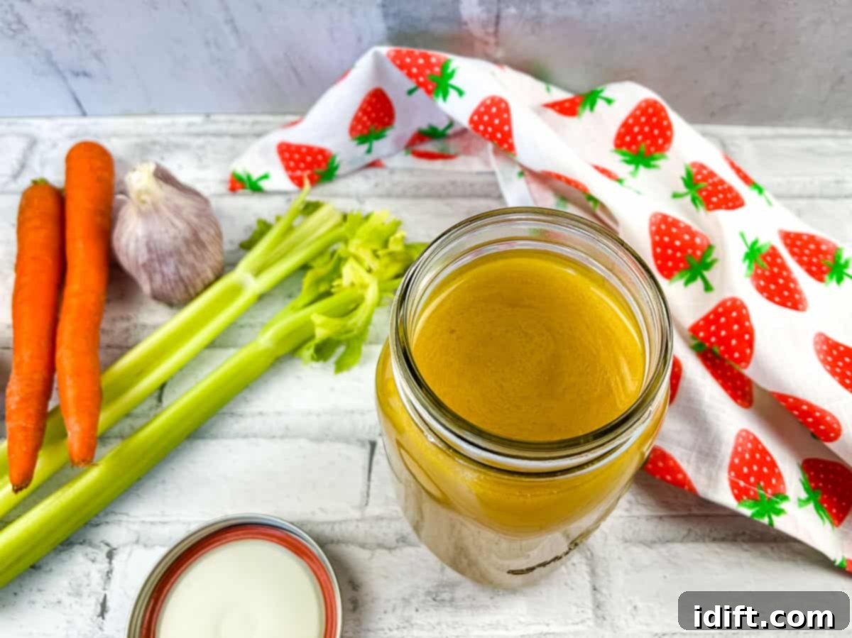 Strained and cooled Instant Precision Dutch Oven Turkey Stock in a jar, ready for culinary use.