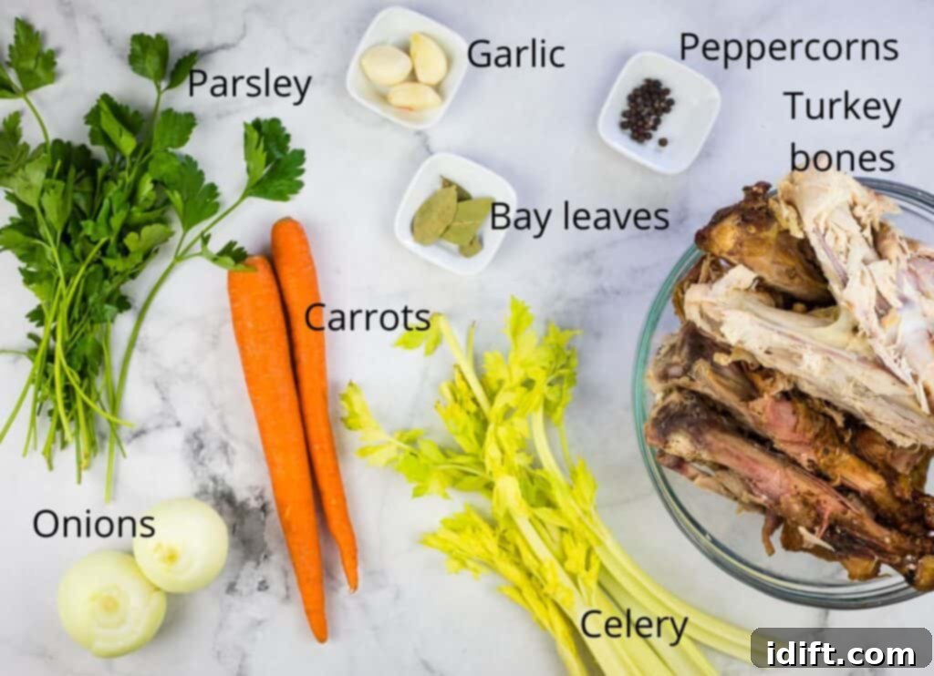 Fresh ingredients laid out for making turkey stock, including carrots, onion, celery, garlic, parsley, bay leaves, peppercorns, and cooking oil.