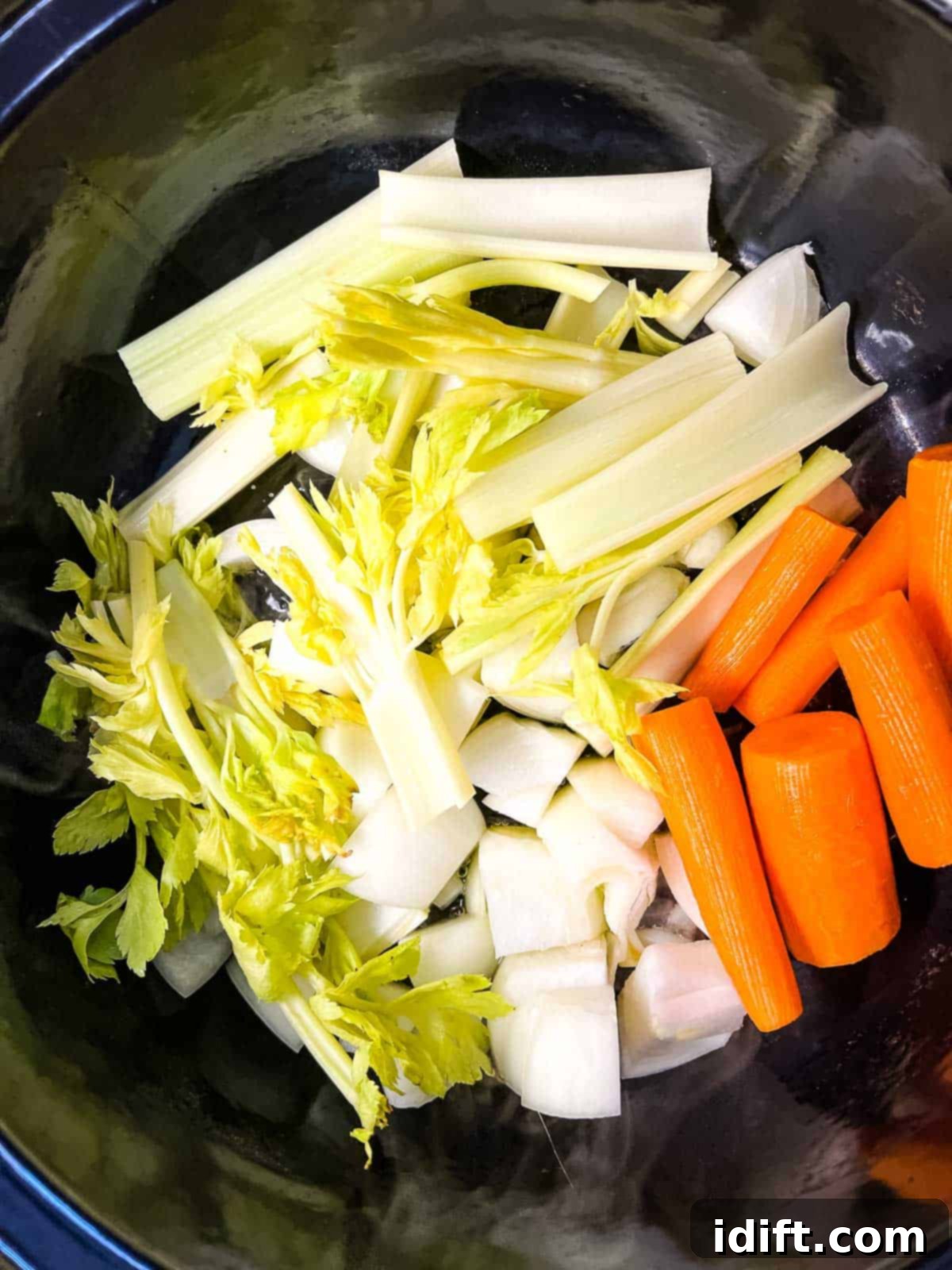 Chopped carrots, onion, and celery sautéing in the Instant Precision Dutch Oven.