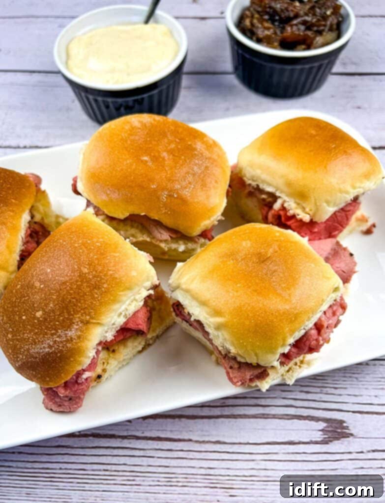 Smoked French Dip Sliders on a white platter.