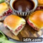 Smoked French Dip Sliders on a cutting board with jus in the middle.