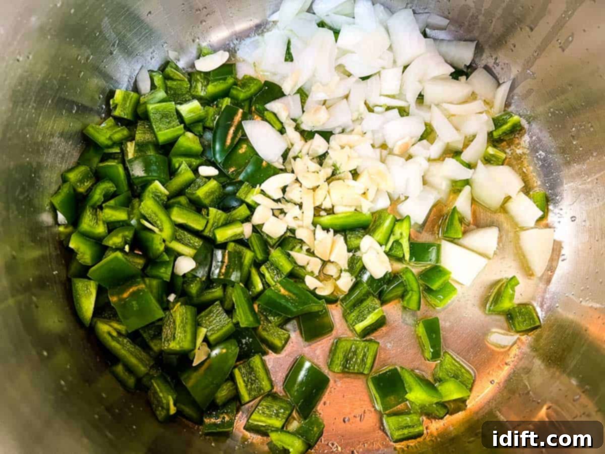 Jalapeno Velvet Warmth 6 Onions and jalapenos gently sautéing in melted butter in a heavy-bottomed pot, becoming tender and translucent.
