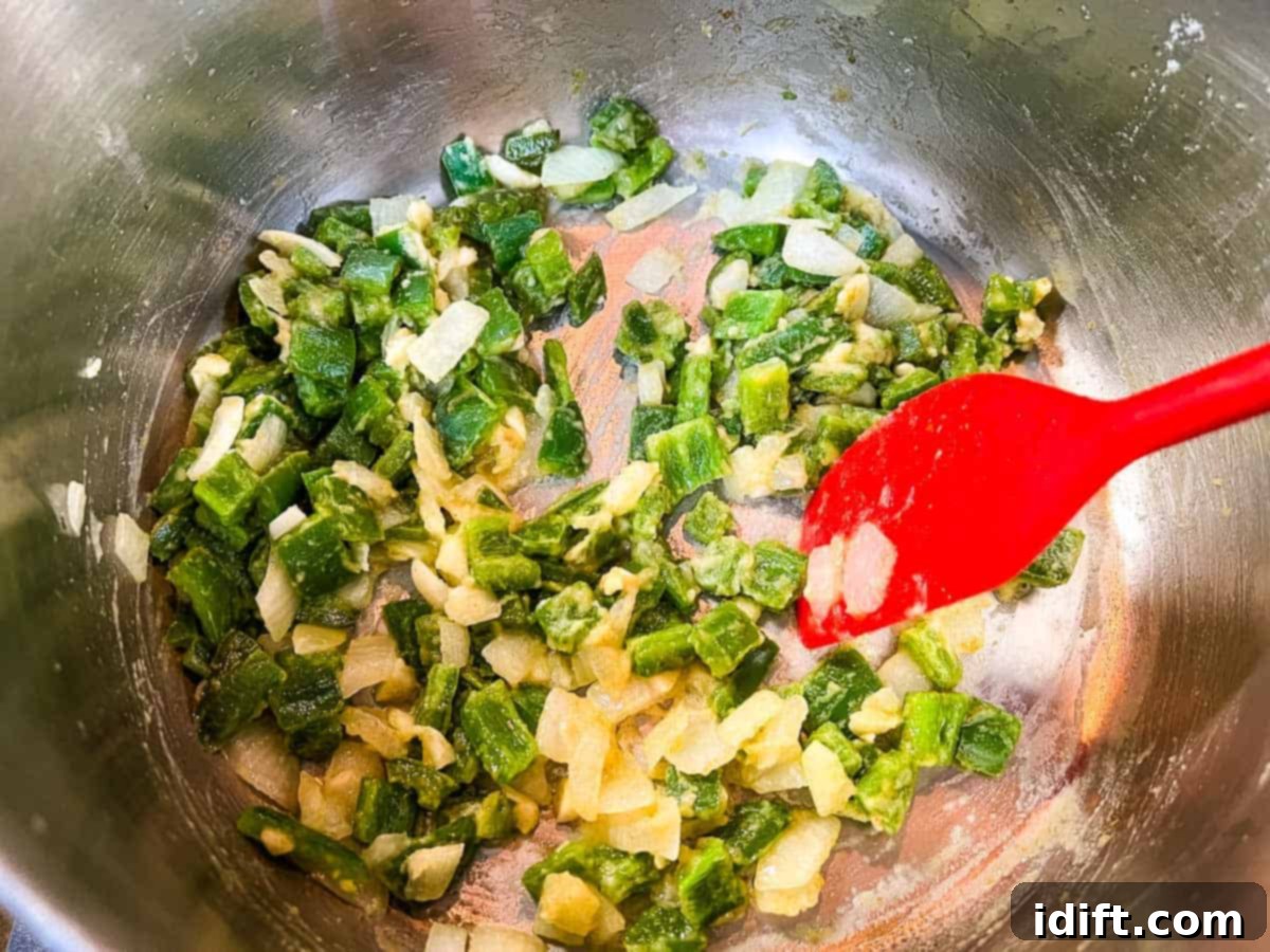 Jalapeno Velvet Warmth 7 Finely minced garlic and flour added to the sautéed vegetables in the pot, stirring to form a roux.