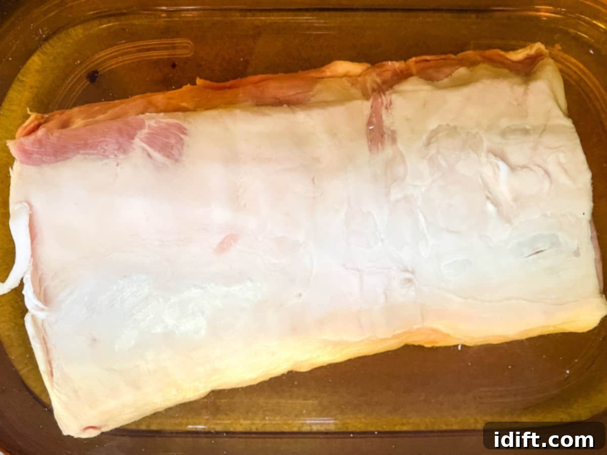 Raw pork loin in the brine in the fridge.