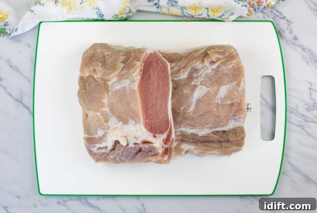 Cured peameal bacon cut into chunks and ready for rolling in cornmeal.