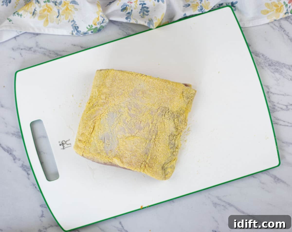 Cornmeal coated peameal bacon ready for slicing.