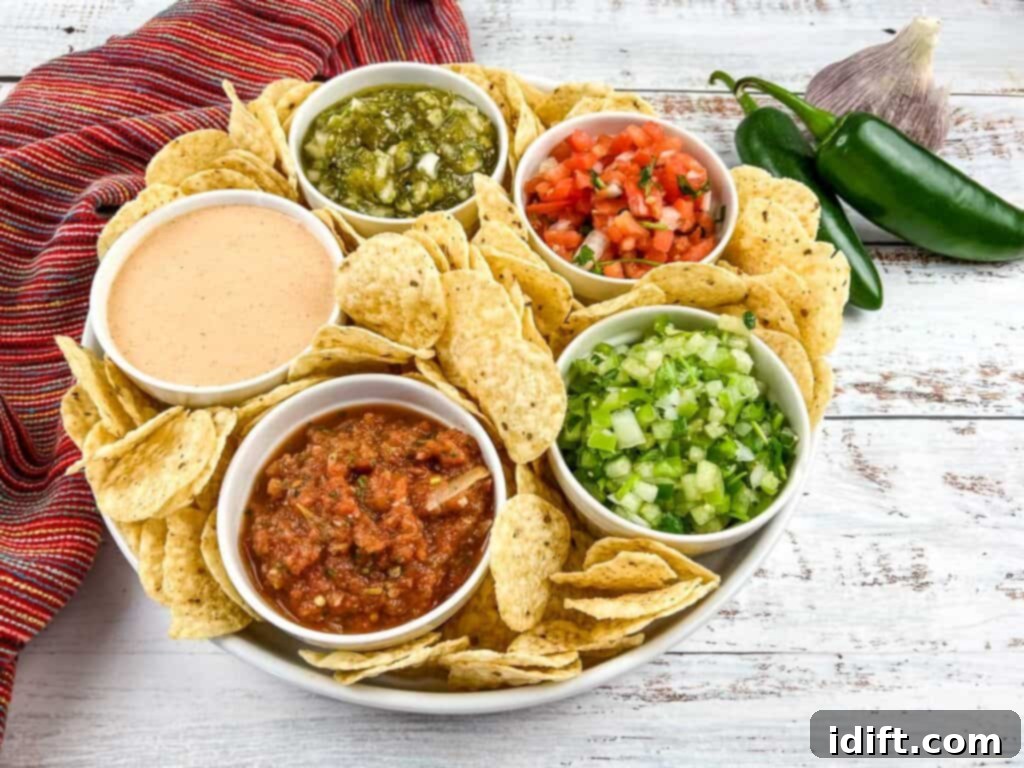 Dips, salsas, and pico de gallo in a serving bowl with tortilla chips.