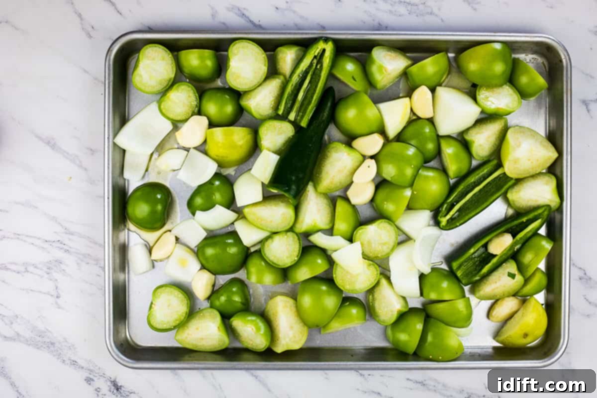 Veggies on a sheet pan ready for roasting.