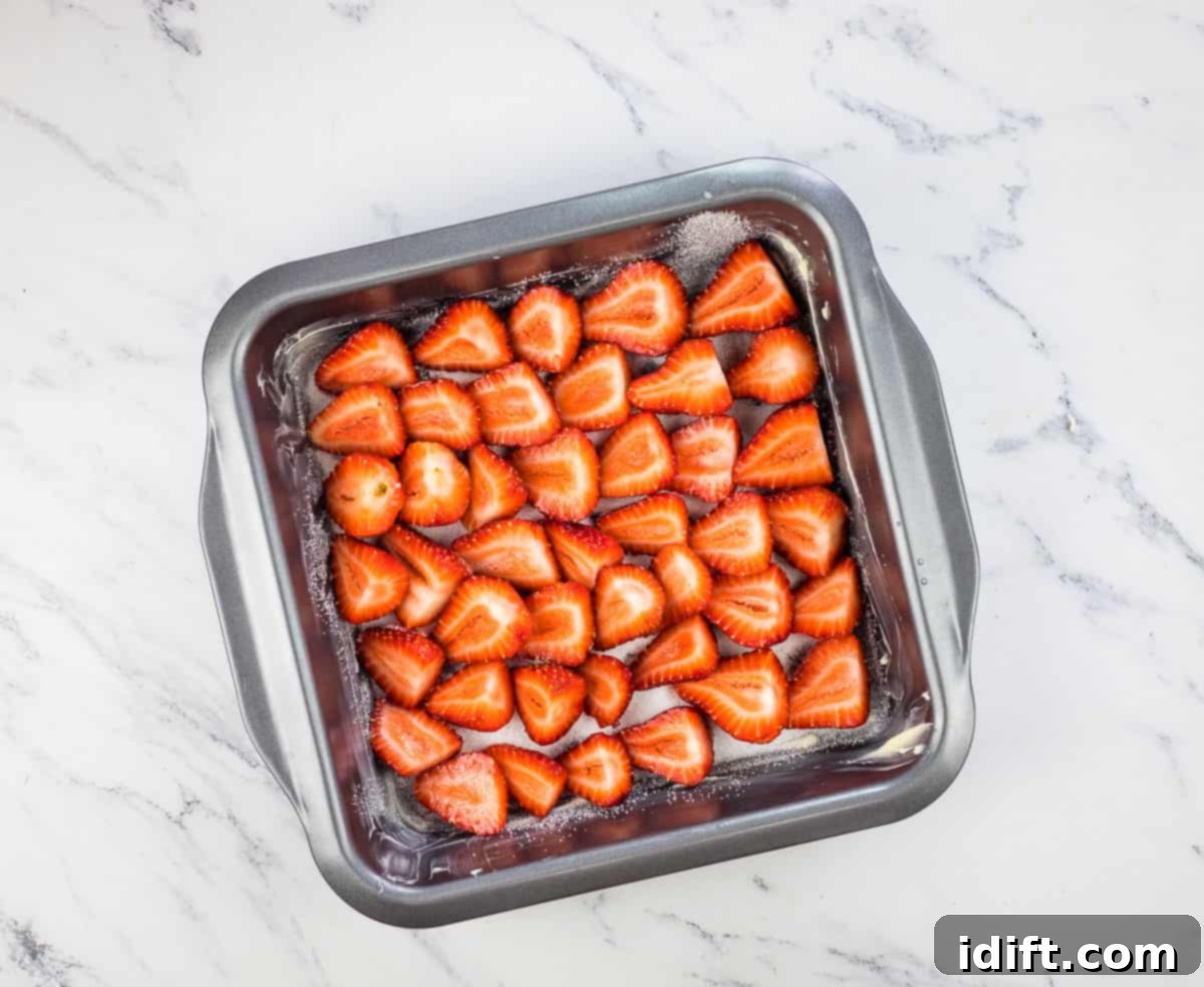 Arranged strawberries in the bottom of the baking dish.