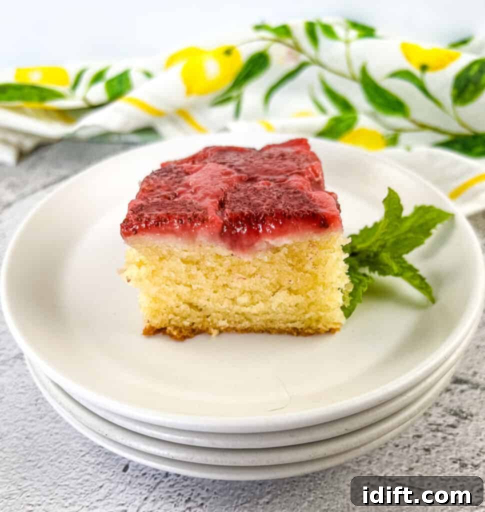 A slice of strawberry cake on a plate.