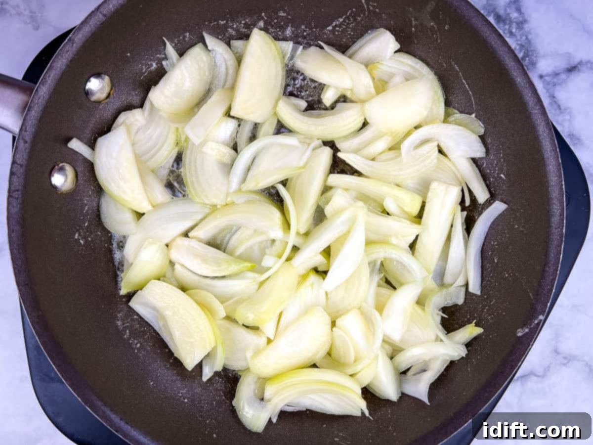 Sweet Caramelized Onion and Umami Mushroom Soup 7 Sliced onions gently cooking in melted butter in a large skillet, beginning their caramelization journey.