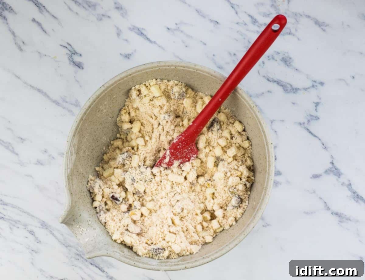Wholesome Apple Date Walnut Muffins 8 Diced apples, dates, and walnuts added to the dry flour mixture in a large bowl.