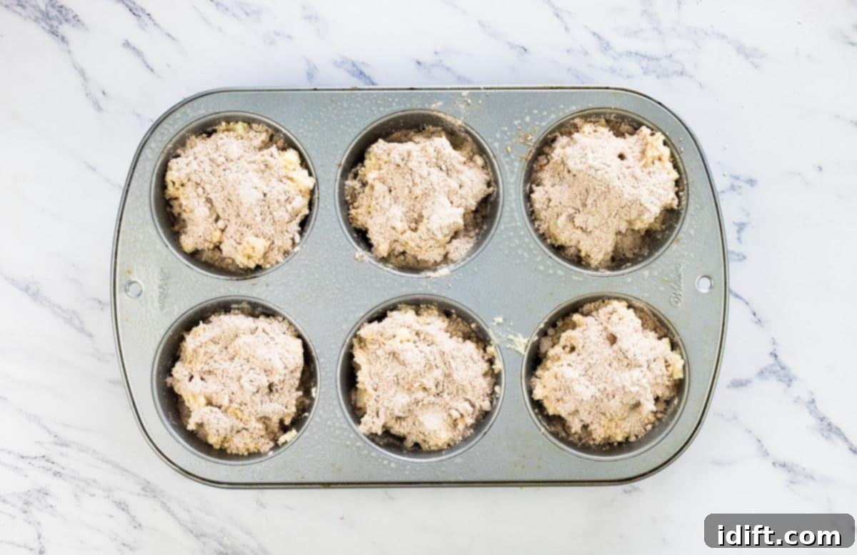 Wholesome Apple Date Walnut Muffins 11 Muffin cups filled approximately 3/4 full with Apple, Date, and Walnut batter, ready for topping.