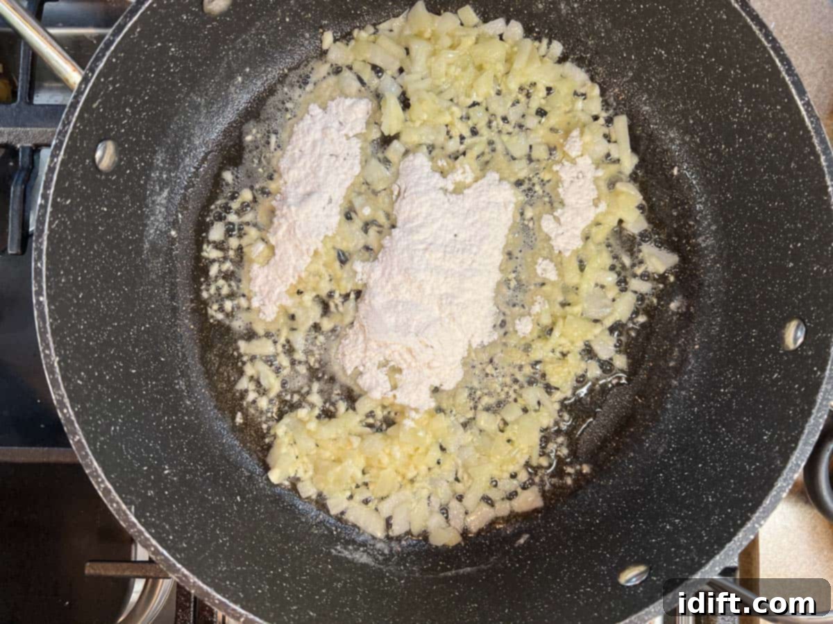 Mixing the flour into the cooked onions and garlic.