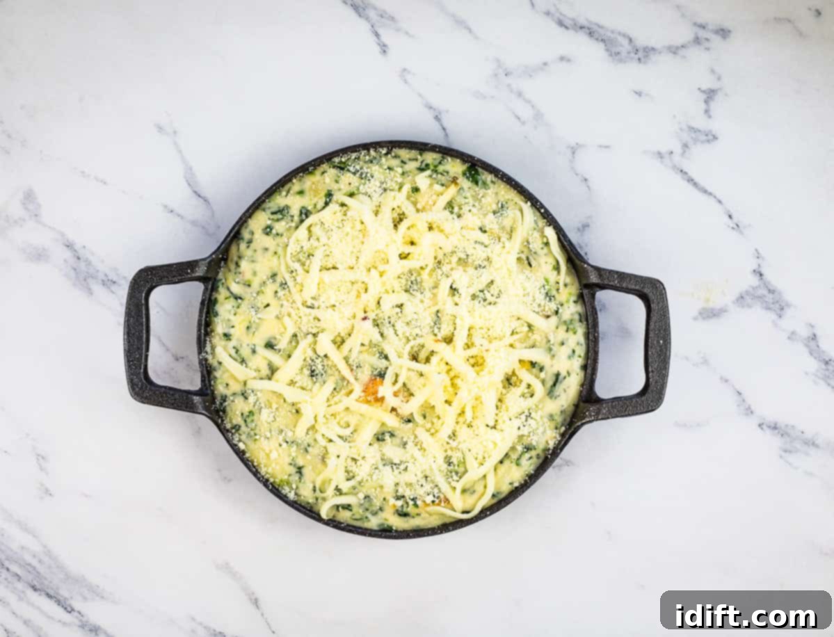 Spinach and Brie Dip in a baking dish ready for the oven.