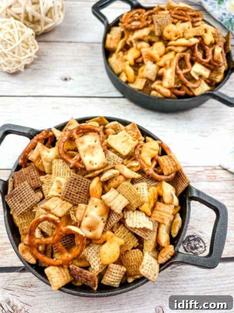 Smoked Chex Mix in 2 cast iron bowls.