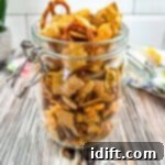 Smoked chex mix in a glass jar.