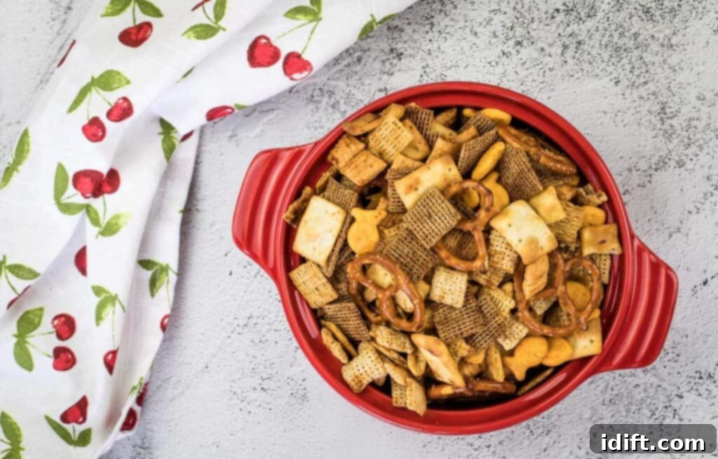 A top-down shot of Smoked Chex Mix in a red bowl.