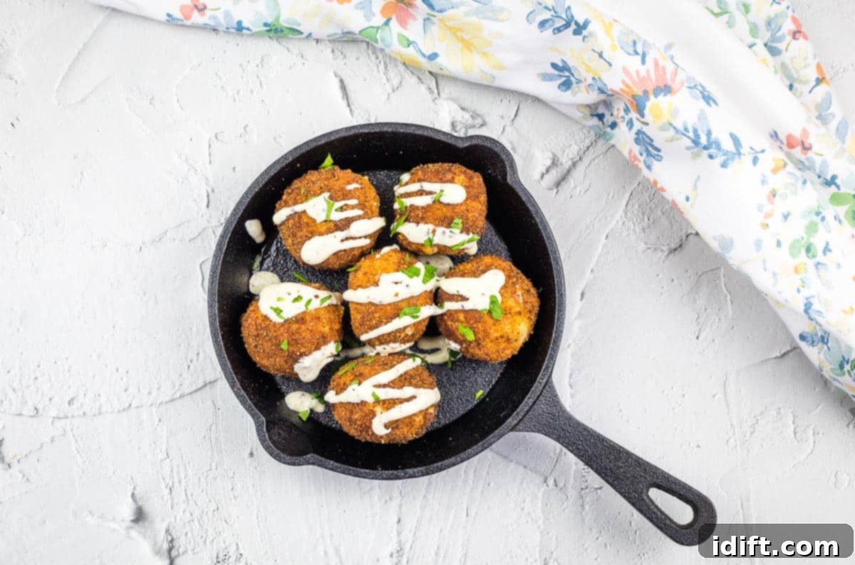 Savory Kraut Poppers 16 Sauerkraut balls in a black dish.