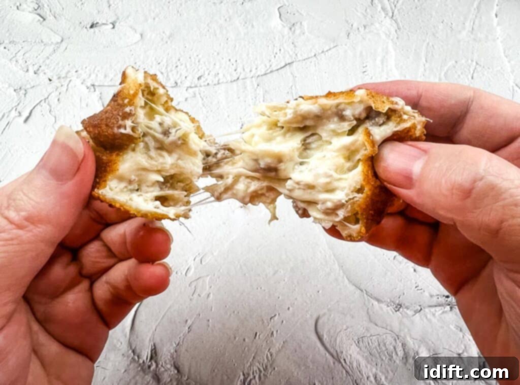 Savory Kraut Poppers 3 A sauerkraut ball being pulled apart.