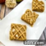 Three Brown Butter Apple Blondies, freshly cut and arranged on a white platter.