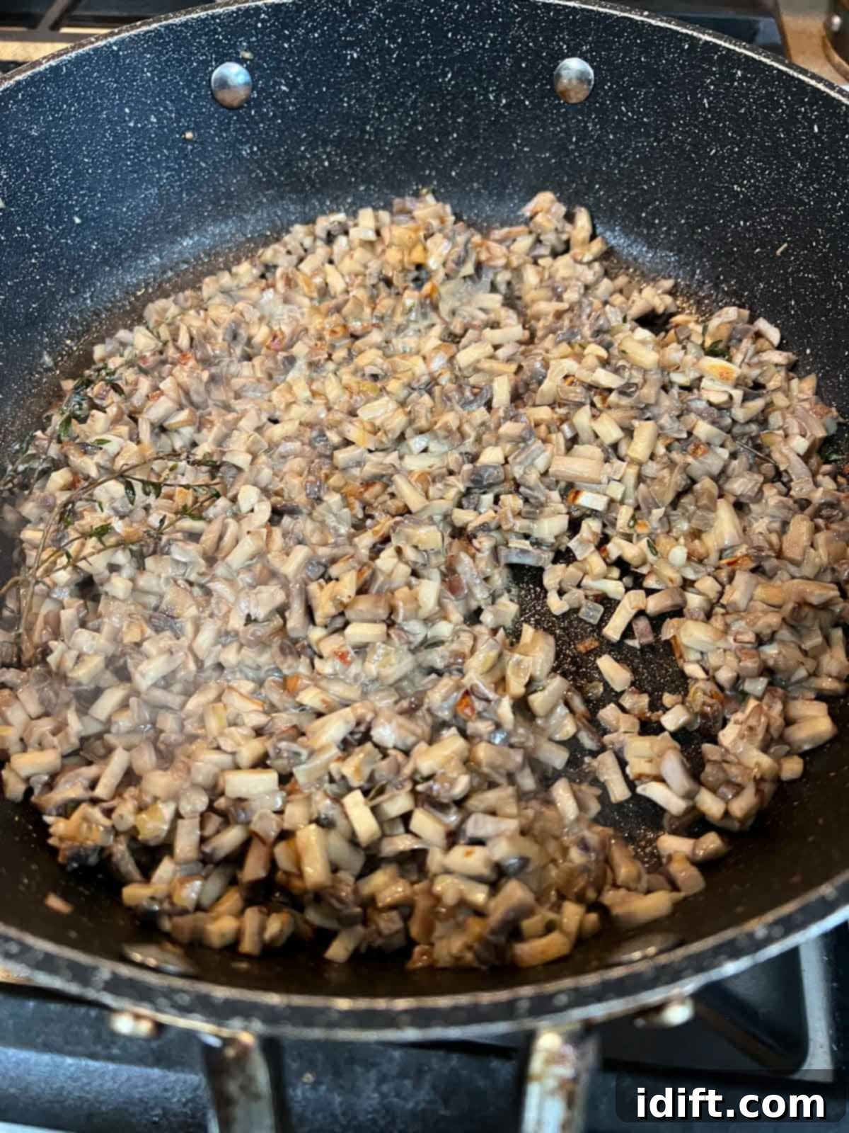 Sauted mushrooms with cream in a skillet.