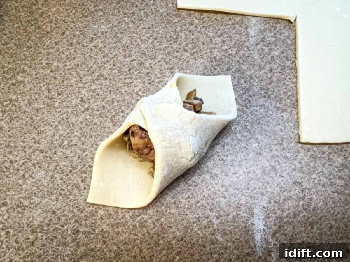 Opposite corners of the pastry folded over and sealed.