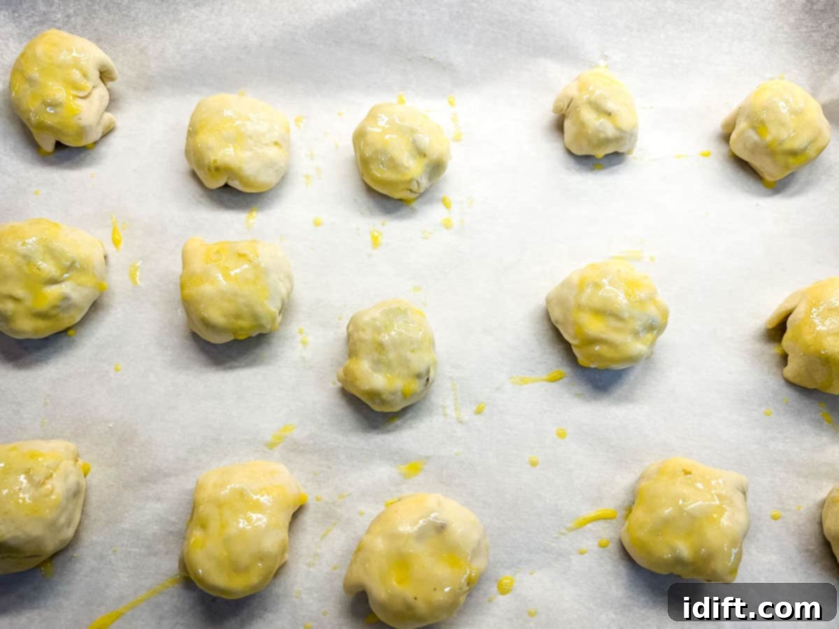 A pan of Beef Wellington Bites brushed with egg wash.