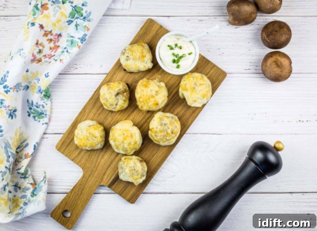 A top-down shot of Beef Wellington bites on a board with mushrooms in the background.