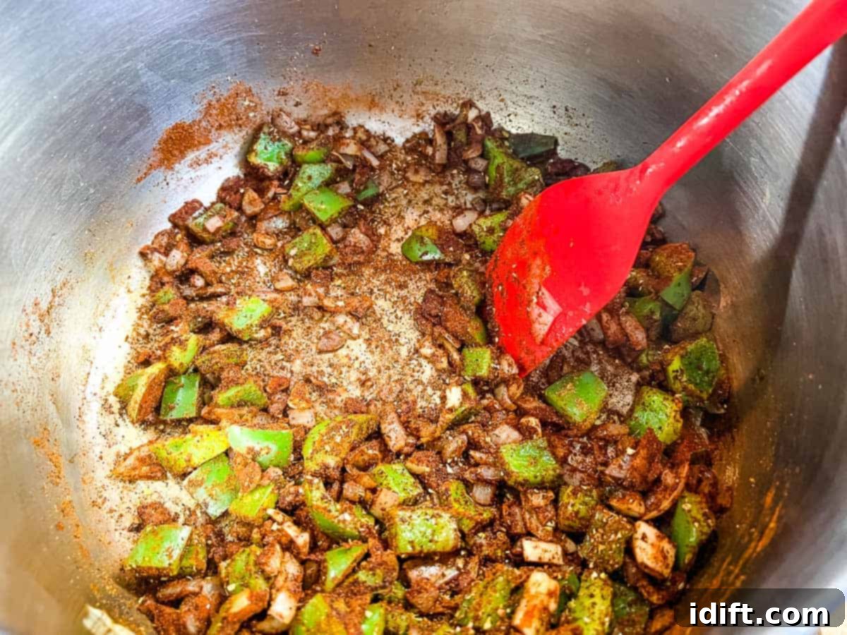 Spices added to the cooking onions and peppers.