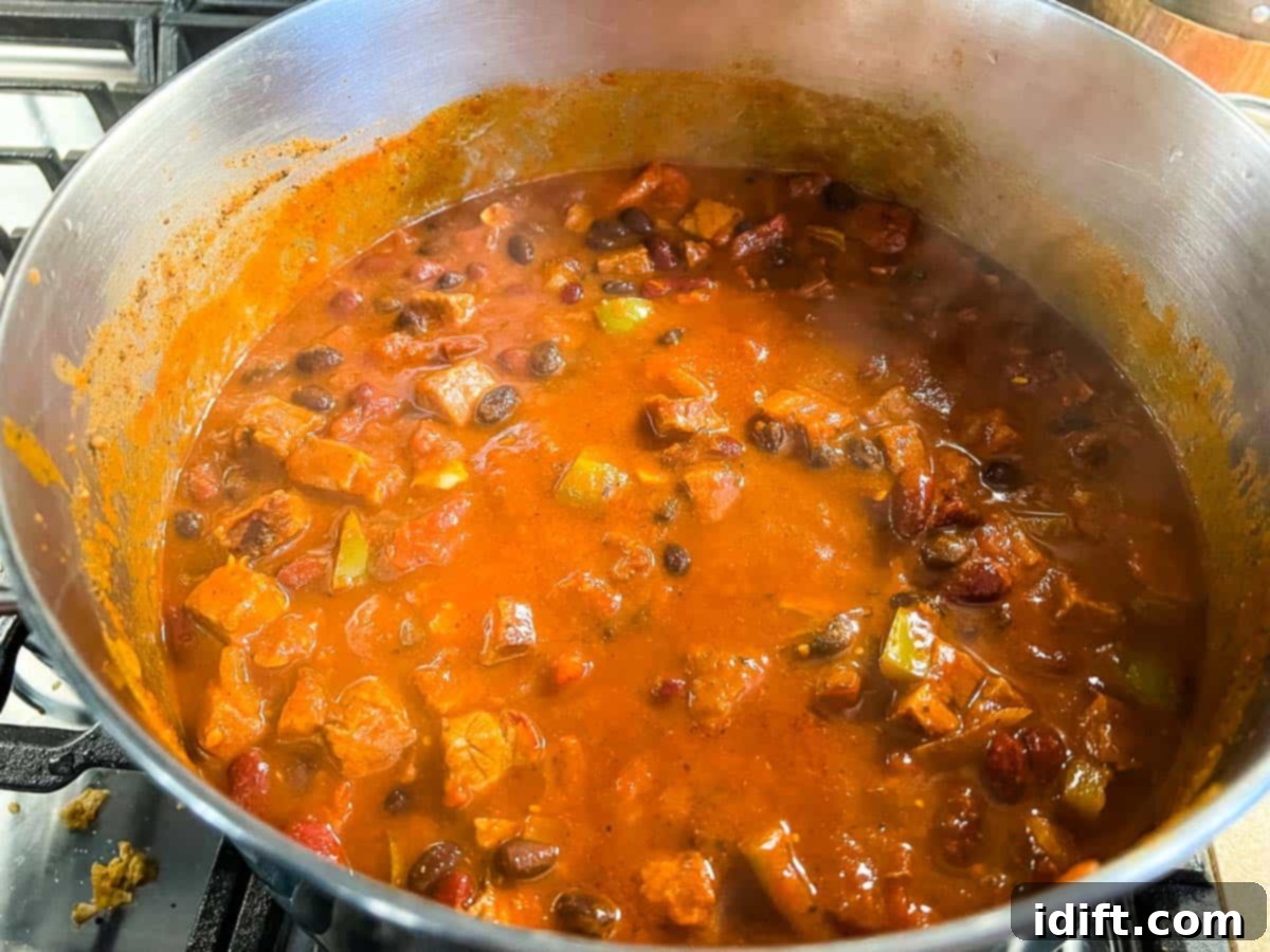 Adding the beans and masa after the brisket is tender.