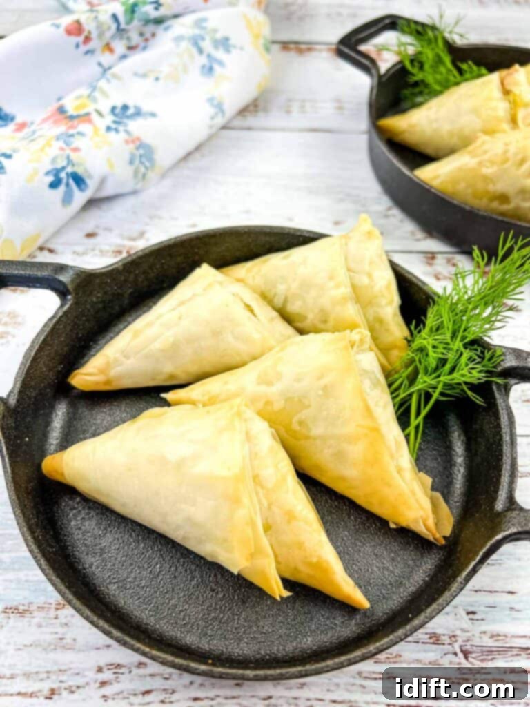 Crab Spanakopita in a black serving dish with a second in the background.