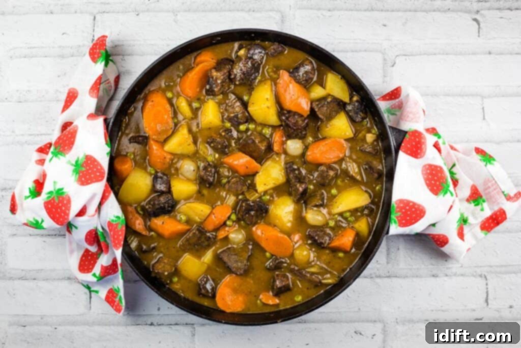 Hearty Smokehouse Beef Stew 5 A bubbling black cast iron dish filled with deeply flavored Smoked Beef Stew, fresh off the smoker, ready to be served.