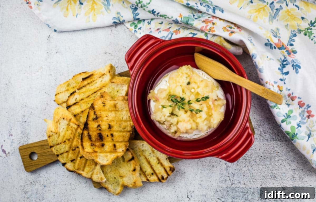The finished Baked Brie with Apple Ginger Chutney, garnished beautifully and ready to be served, showcasing its vibrant colors and inviting texture.