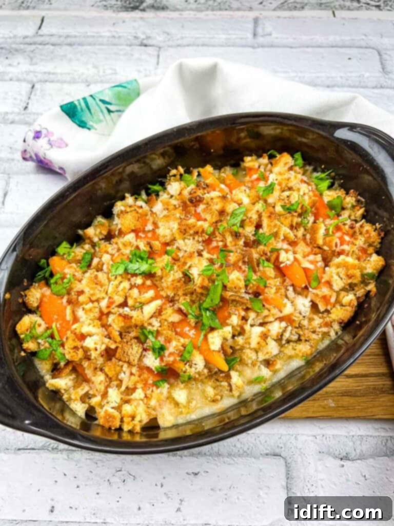 Fiery Crumb Carrot Bake 2 Carrots au gratin served beautifully in a black oval serving dish, ready to be enjoyed.