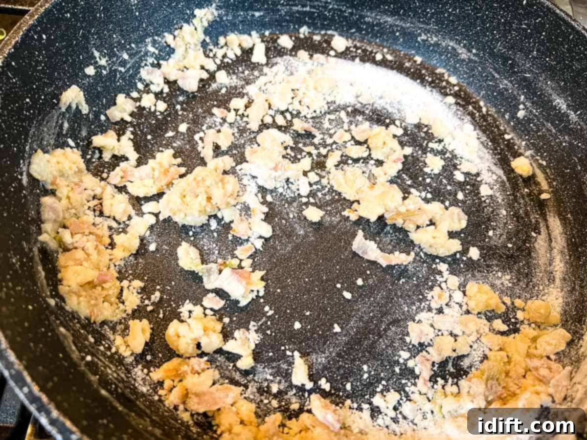 Fiery Breadcrumb Carrot Gratin 8 Adding all-purpose flour to the softened shallots and butter in a saucepan, beginning the roux.