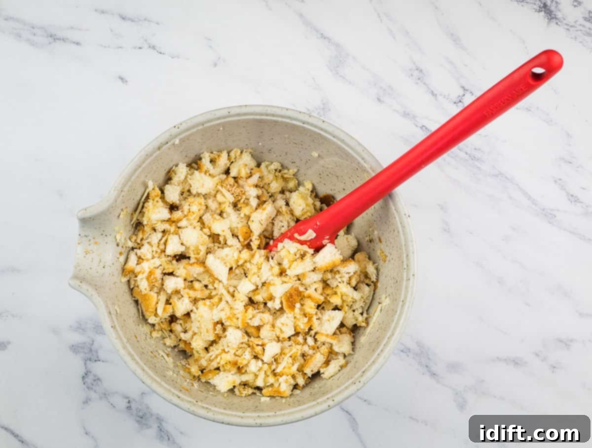 Fiery Crumb Carrot Bake 12 Coarsely crumbled bread mixed with the butter, mustard, horseradish, and cheese mixture in a bowl.