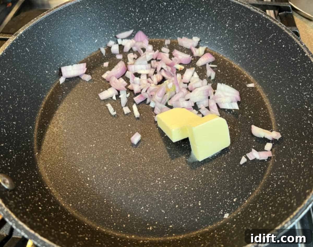 Fiery Crumb Carrot Bake 7 Finely diced shallots gently sautéing in melted butter in a saucepan.