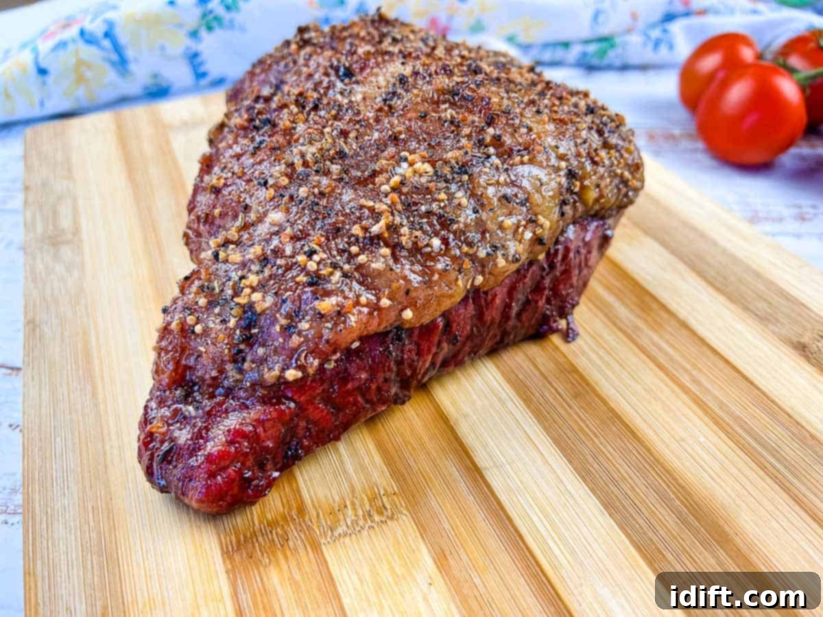 Perfectly Smoked Picanha 9 Smoked Picanha resting on a cutting board after cooking, showing its crispy fat and juicy interior.