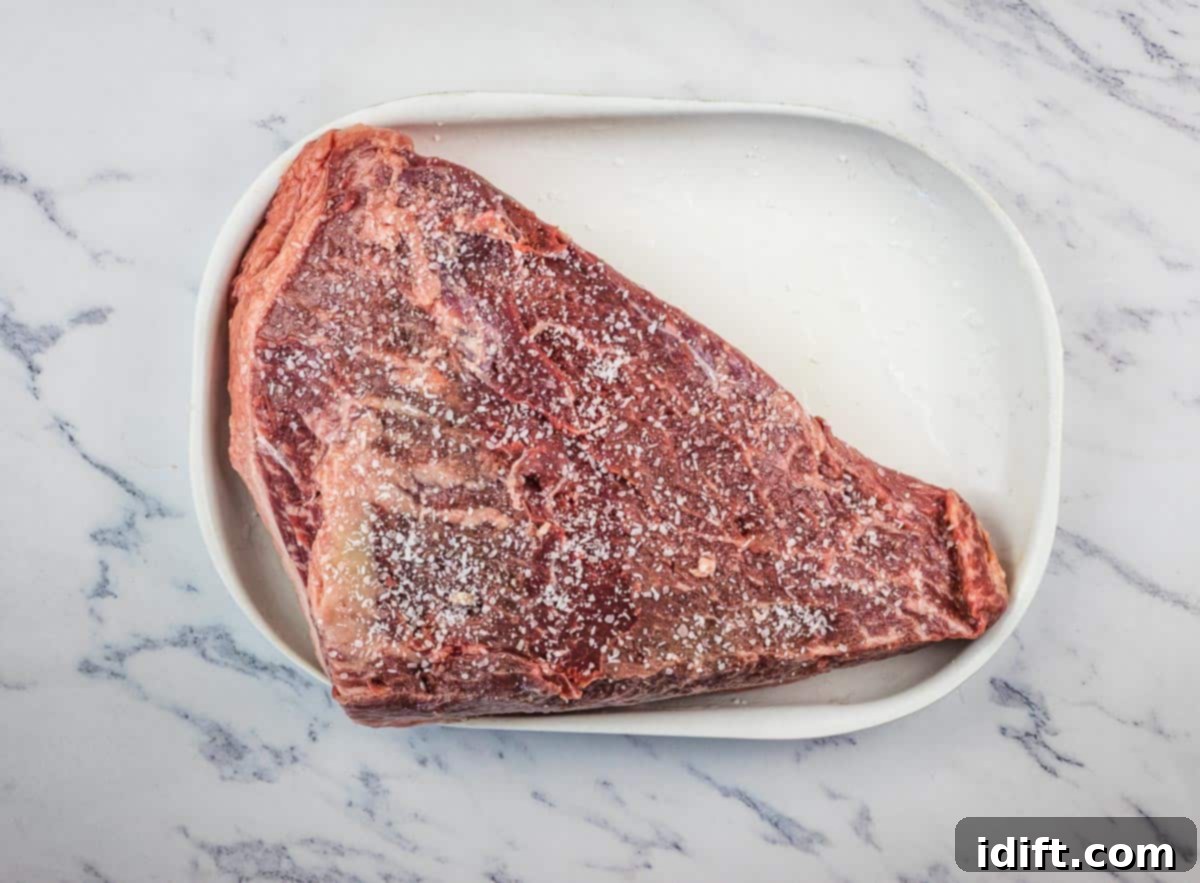 Perfectly Smoked Picanha 7 Picanha roast with the underside liberally salted, showcasing the initial seasoning step.