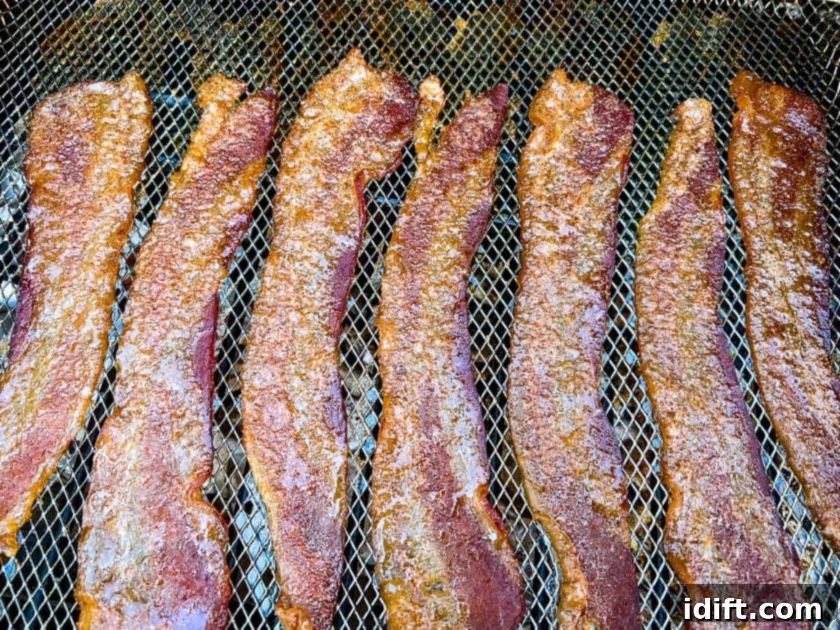 Millionaire's Bacon 9 Smoked Candied Bacon on a rack on the smoker.