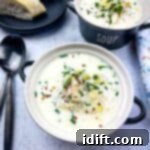 Two black bowls of Cullen Skink with bread in the background.