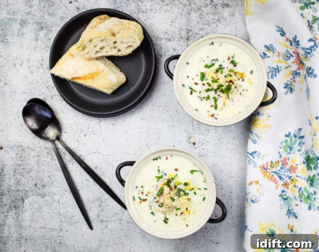 A top-down shot of two bowls of creamy Cullen Skink, garnished with fresh herbs, ready to be served.