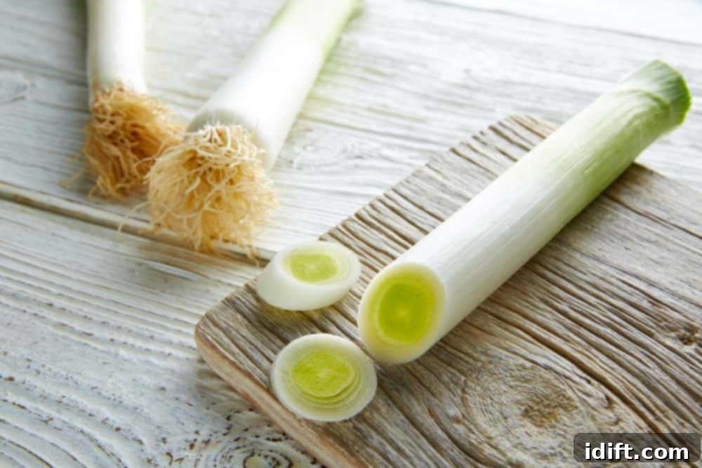 Freshly cleaned leeks, ready for preparation, showcasing their layered structure.